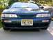 1995 Nissan 240SX - Front view of a dark teal 1995 Nissan 240SX parked on a concrete driveway.