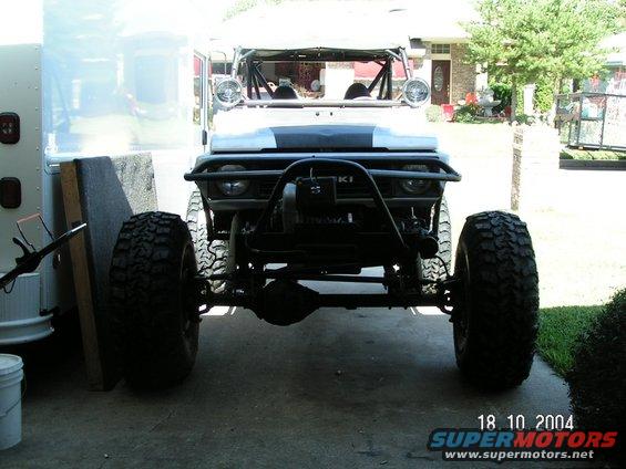 Suzuki Samurai front view with large tires and roll cage