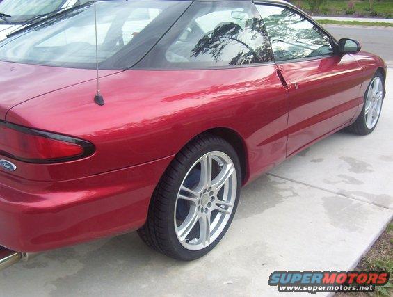 Red 1997 Ford Probe parked on a concrete driveway