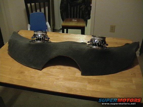 Two car speakers mounted on a dark gray, curved pod