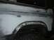 1984 Ford Bronco - This 1980s Ford Bronco is undergoing bodywork, with primer and filler visible on the rear quarter panel.