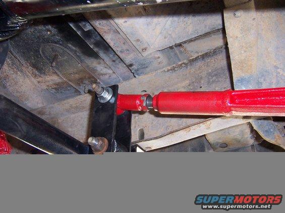 close-up of red traction bar attached to vehicle frame