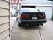 1995 Ford Taurus - Rear view of a black 1995 Ford Taurus sedan parked in a driveway.