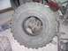 1978 Ford Bronco - Close-up of a Super Swamper tire and visible suspension parts, not a complete vehicle.