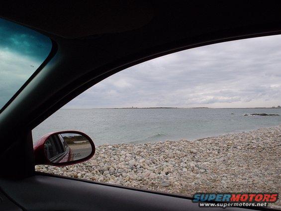 view out car window at rocky beach and ocean