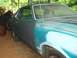 1977 Ford Mustang II - Side view of a 1977 Ford Mustang II undergoing restoration with primer and teal paint.