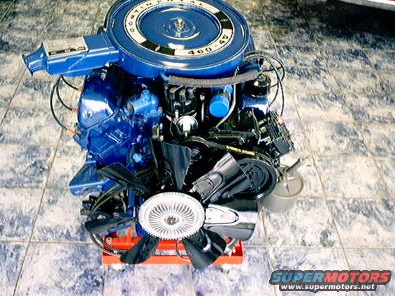 Blue Ford 400 V8 engine with a chrome air cleaner and fan, mounted on an orange stand
