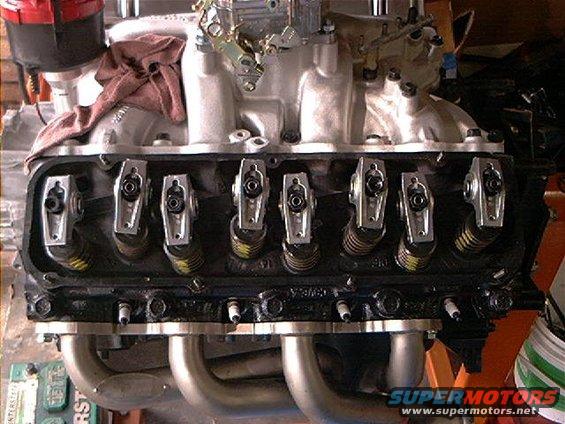 Close-up of a V8 engine's valve train with rocker arms and springs visible