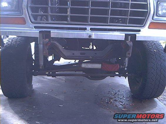 front end of a lifted truck, showing grille, bumper, and suspension components