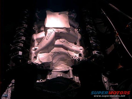 Close-up of an engine intake manifold with 'Edelbrock PERFORMER RPM' visible