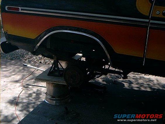 1979 Ford Bronco rear axle assembly removed and supported by jack stands