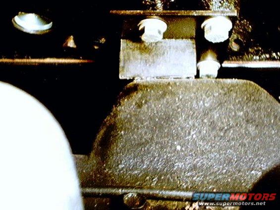 close-up of a greasy metal part with bolts
