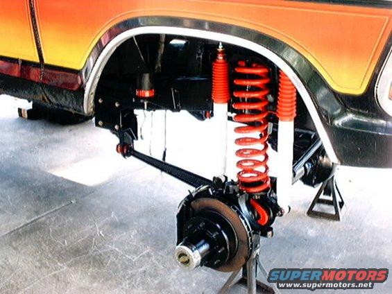 1979 Ford Bronco front suspension with red coilover shocks and disc brake assembly