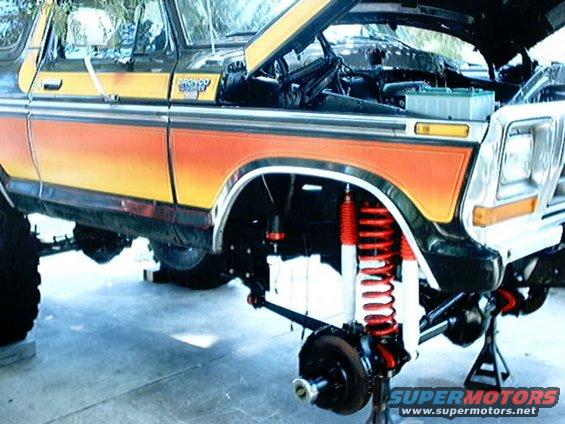 Ford Bronco lifted with custom suspension, hood open, front wheel removed