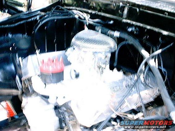 Engine bay with air filter and distributor cap visible