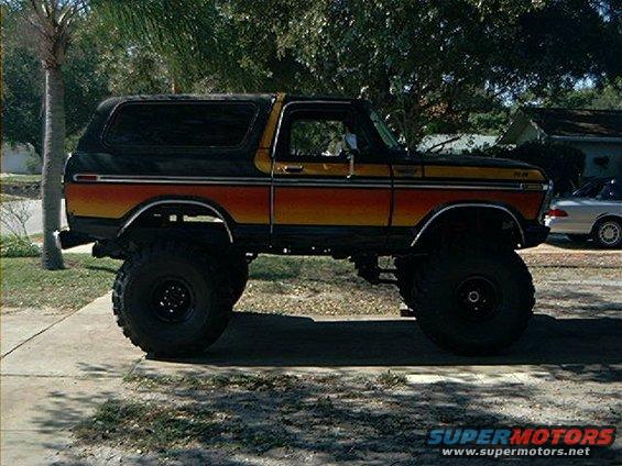 Lifted 1979 Ford Bronco, side view, black with orange and yellow stripes