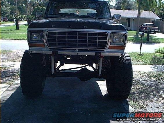 Front view of a lifted Ford truck with a prominent grille and large tires