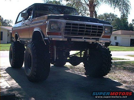 Lifted Ford Bronco with large tires, front view. Grille indicates 1978 model year