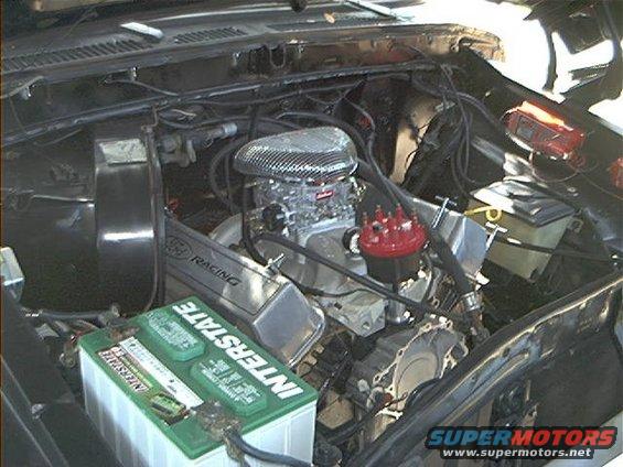 Engine bay with V8 engine, chrome air cleaner, and Interstate battery