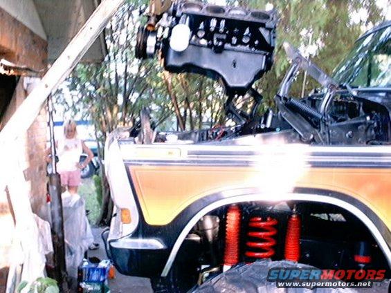 1979 Ford Bronco with engine being removed, front view, orange and black paint