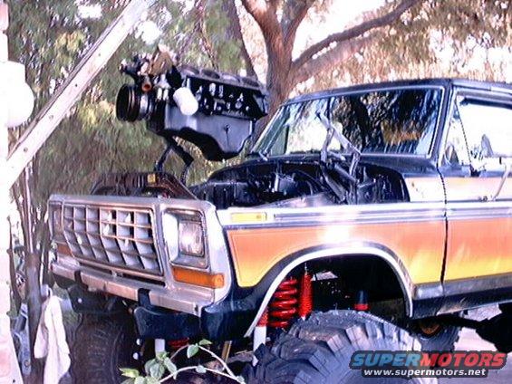 1978 Ford Bronco front end with hood open, engine being lowered in