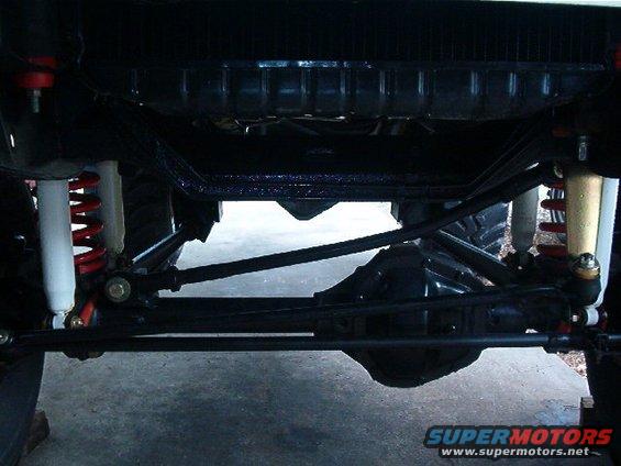 Undercarriage view of a 4x4 vehicle showing suspension components and differential