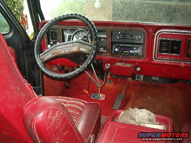 1979 Ford Bronco interior with red seats and dashboard, aftermarket stereo