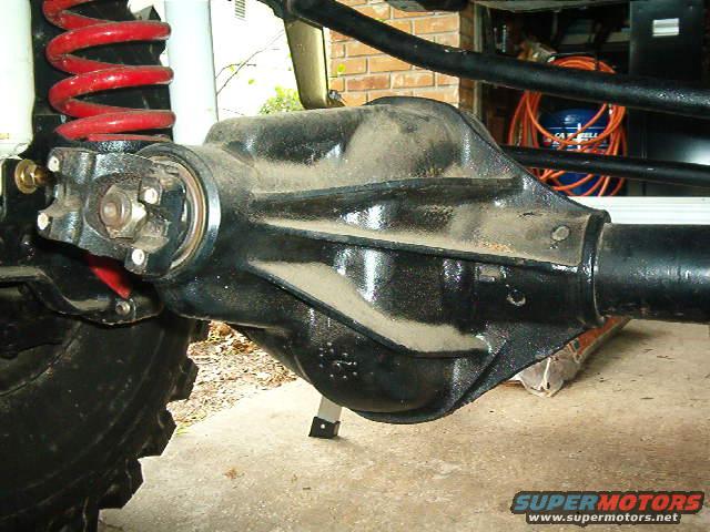 Rear axle assembly with red coil spring and driveshaft