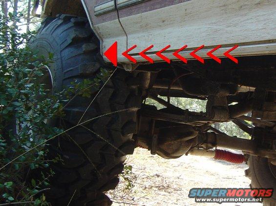 Side view of 1993 Ford Bronco with large off-road tires and suspension components
