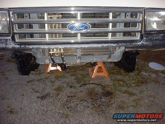Front grille and axle of a 1988 Ford Bronco on jack stands