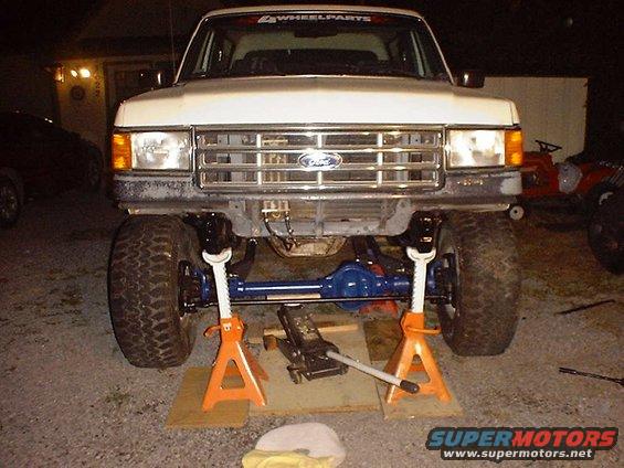1987 Ford Bronco front end with axle removed and supported by jack stands