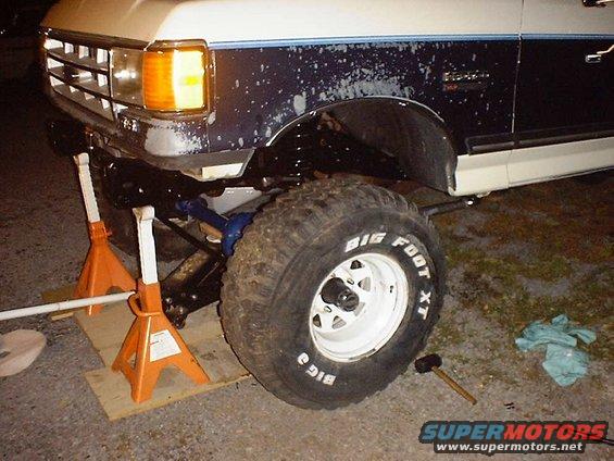 Ford Bronco front axle with Big Foot XT tires on jack stands