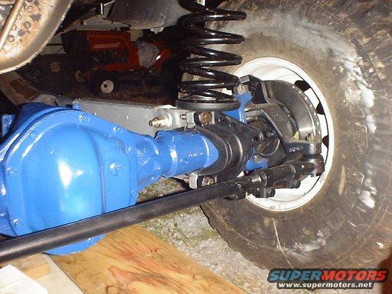 Blue painted front axle assembly with black shock absorber and tire