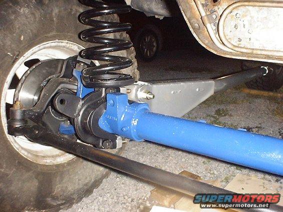 Front axle assembly with blue painted axle tube and black coil spring
