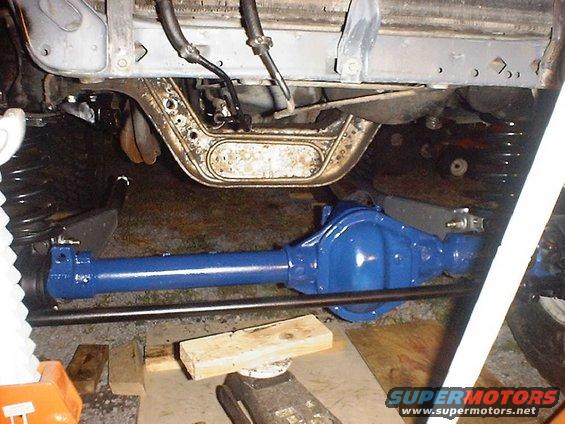 blue painted front axle assembly with suspension components