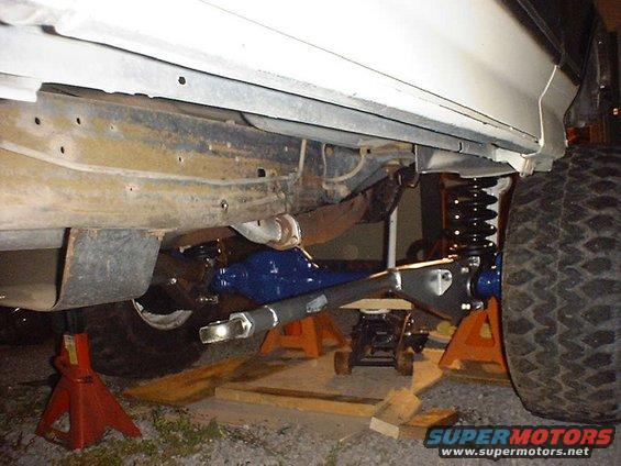 Front axle assembly with blue differential and suspension components on jack stands
