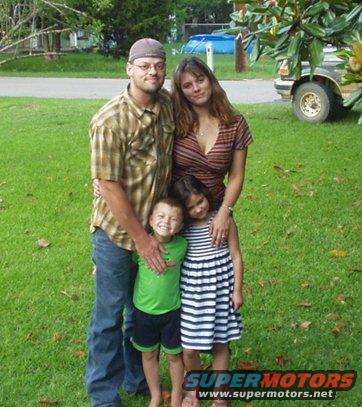 Family of four in front of a 1995 Ford Bronco