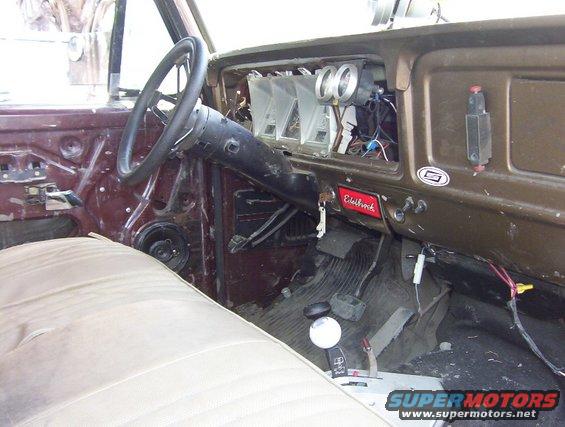 Truck interior with tan seat, dark brown dashboard, and steering wheel. Edelbrock sticker visible