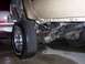 2000 Ford F-450 - A close-up view of a truck's rear wheel, suspension, and drivetrain components.