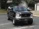 2003 Ford Excursion - This black 2003 Ford Excursion features a lifted suspension and a prominent grille.