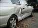 2001 Hyundai Accent - Silver sedan shows extensive damage to the rear quarter panel and door, with another vehicle visible in the background.