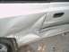 2001 Hyundai Accent - The side of a silver car shows significant damage to the rear door and fender area, with visible dents and scrapes.