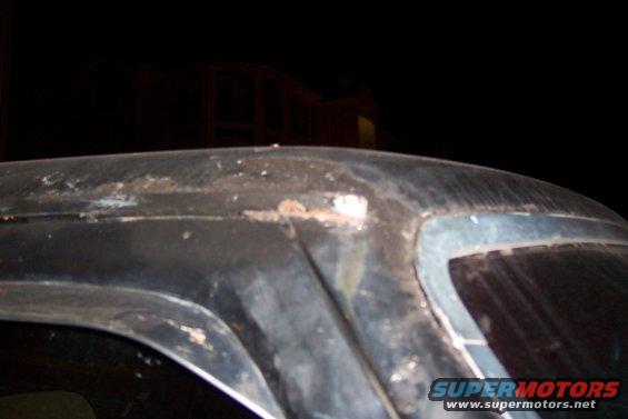 rusted car roofline with visible damage and a Supermotors watermark