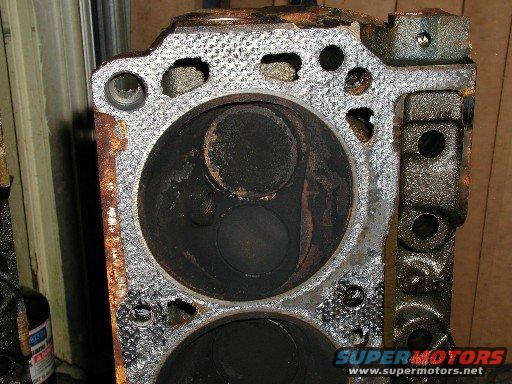 Engine cylinder head with carbon buildup in cylinders