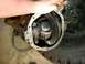 1995 Ford Bronco - A person is holding an open differential gear assembly, revealing the internal gears.
