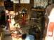 1995 Ford Bronco - A cluttered garage scene shows parts of two vehicles, tools, and an engine on a stand.