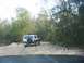 1988 Ford Bronco - This 1988 Ford Bronco navigates a rough, unpaved road surrounded by trees.