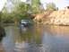 1988 Ford Bronco - Man stands in a river as a 1992 Ford Bronco drives through the water.