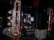 1990 Ford Bronco - A stage setup a lighting truss with multiple spotlights and a drum kit ready for a performance.