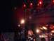 1990 Ford Bronco - A band performs live on a stage with bright lights and a large backdrop.